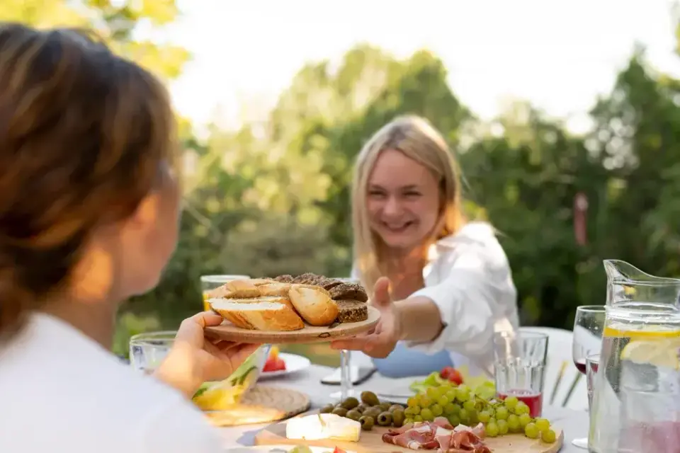 Guest serving herself from a Saffron catering spread at an outdoor lunch